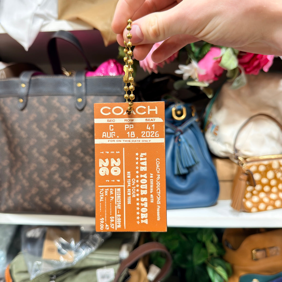 Coach Concert Ticket Bag Charm CHQ91 burnished amber stock photo