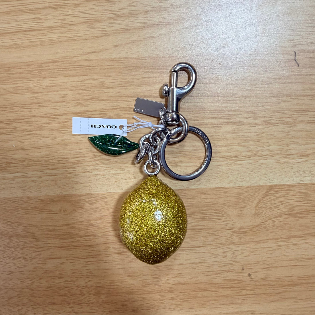 Coach Lemon Bag Charm CAO52 stock photo
