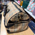 Burberrys duffle bag side view with end zip pocket and strap clip