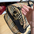 Burberrys logo zipper pull and shoulder strap clip