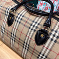 Burberrys duffle leather handle tabs and gold hardware close-up