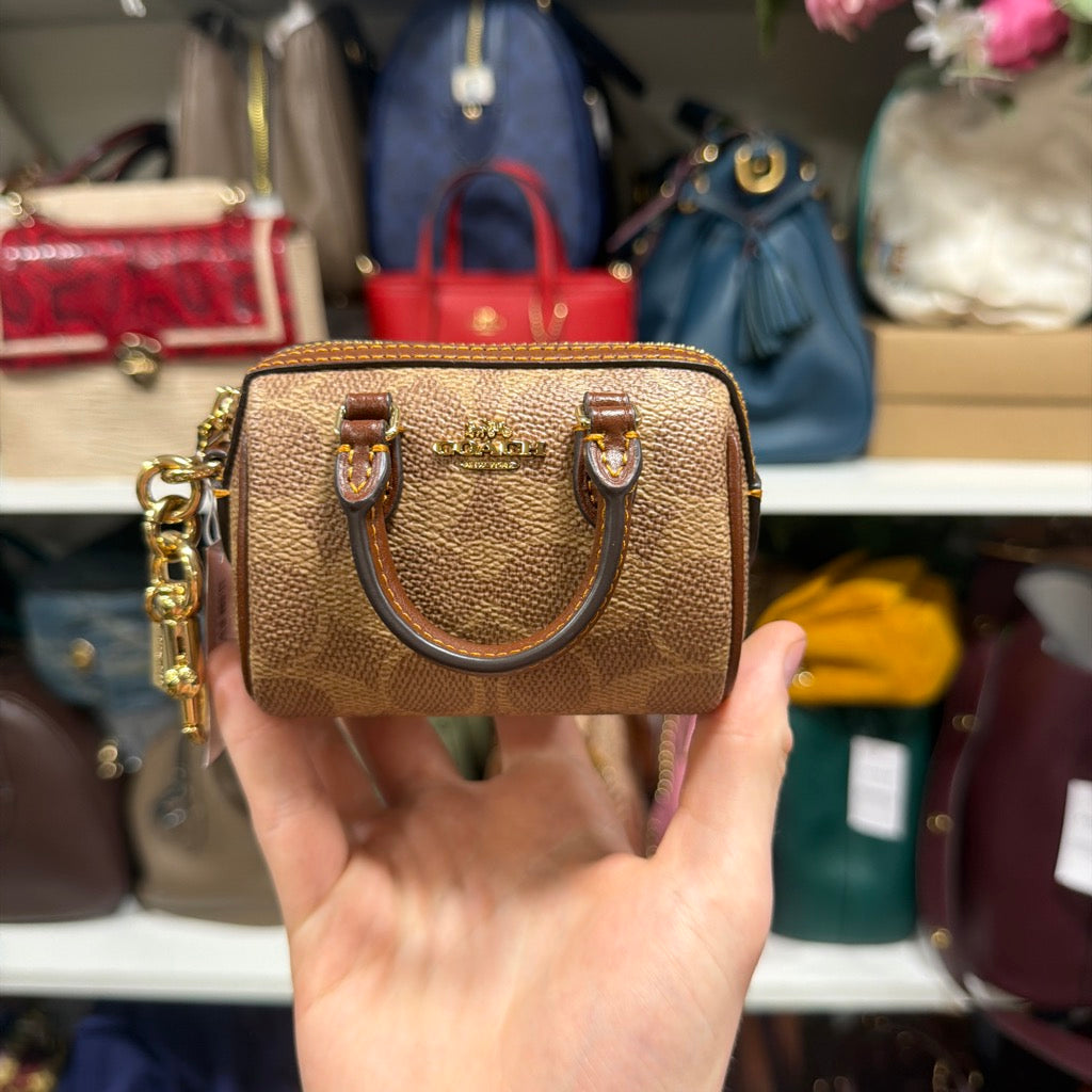 Coach Mini Rowan Bag Charm In Signature Canvas CX068 Gold Tan Brown stock photo