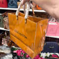 Actual independently upcycled orange shopping-bag tote with clear cover