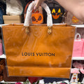 Actual independently upcycled orange shopping-bag tote with clear cover