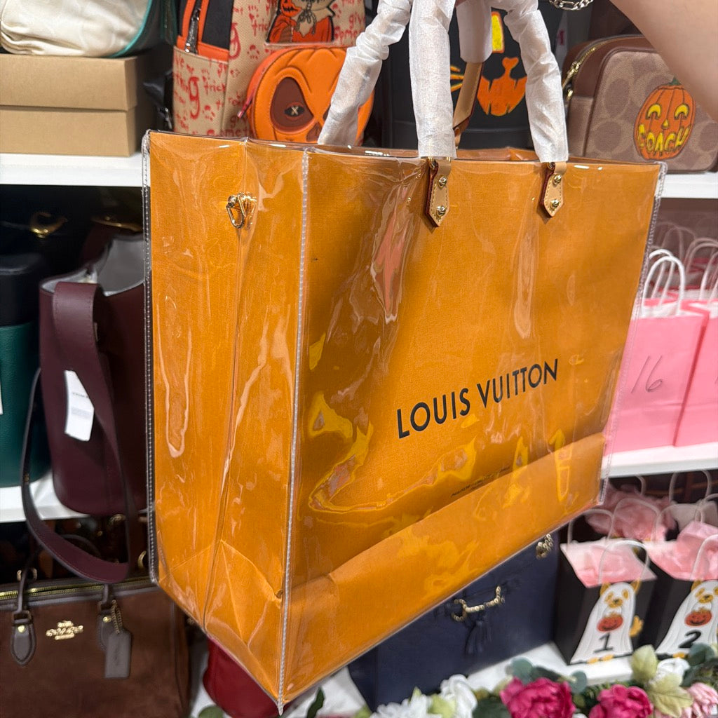 Actual independently upcycled orange shopping-bag tote with clear cover