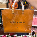 Actual independently upcycled orange shopping-bag tote with clear cover