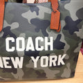 Coach New York graphic and leather hangtag close-up
